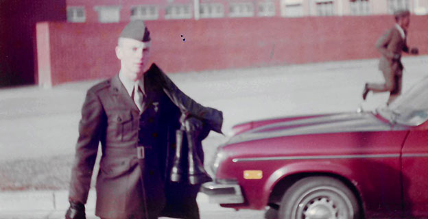 Keith Higgins in his Military Dress uniform walking across the street