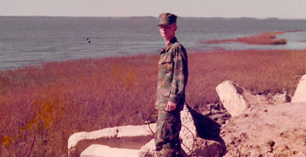 Keith Higgins in his army uniform standing on the coast of St. Simons
